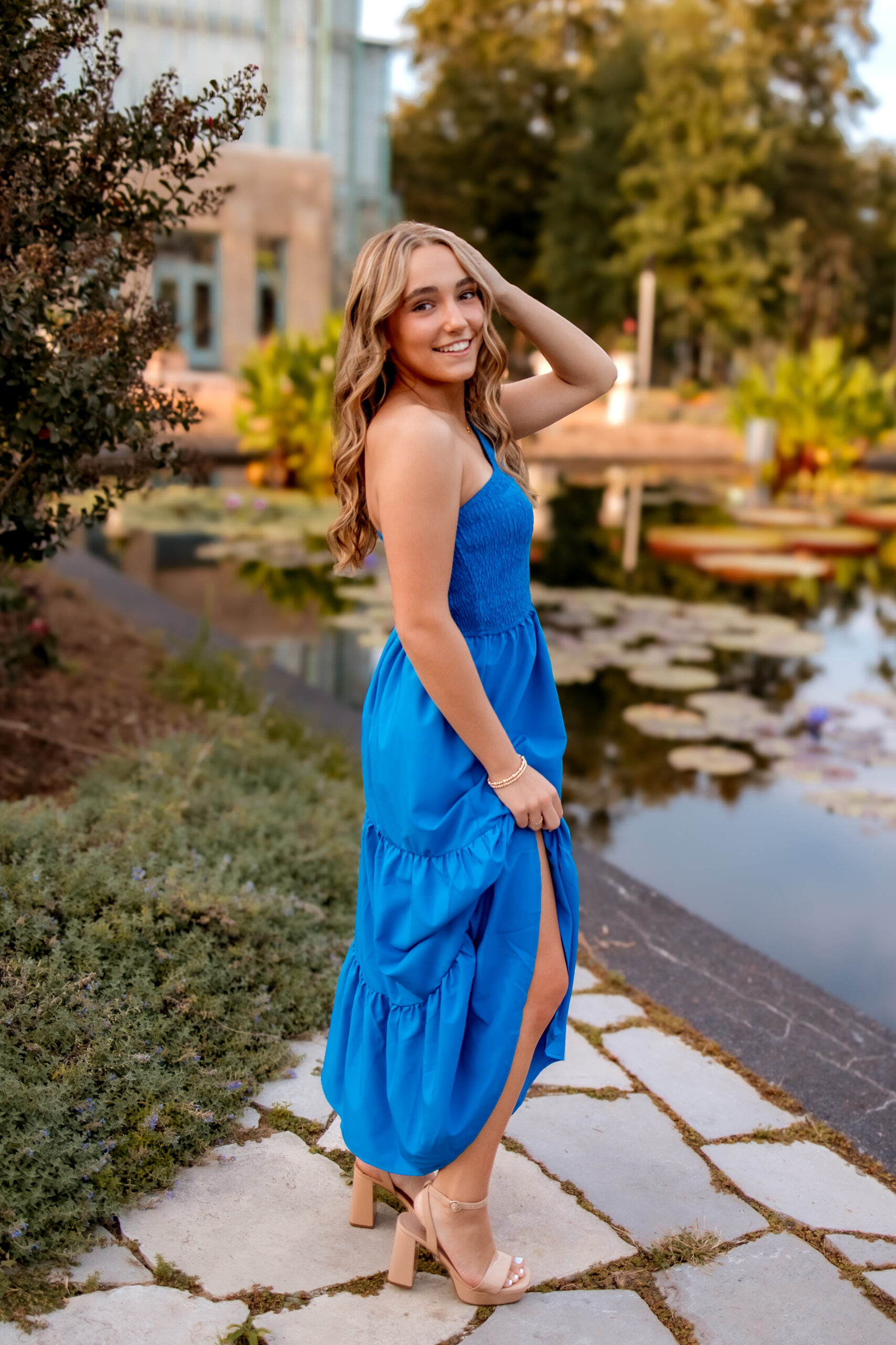 A young girl is dressed in her blue prom dress posing for her St. Louis prom photo session.