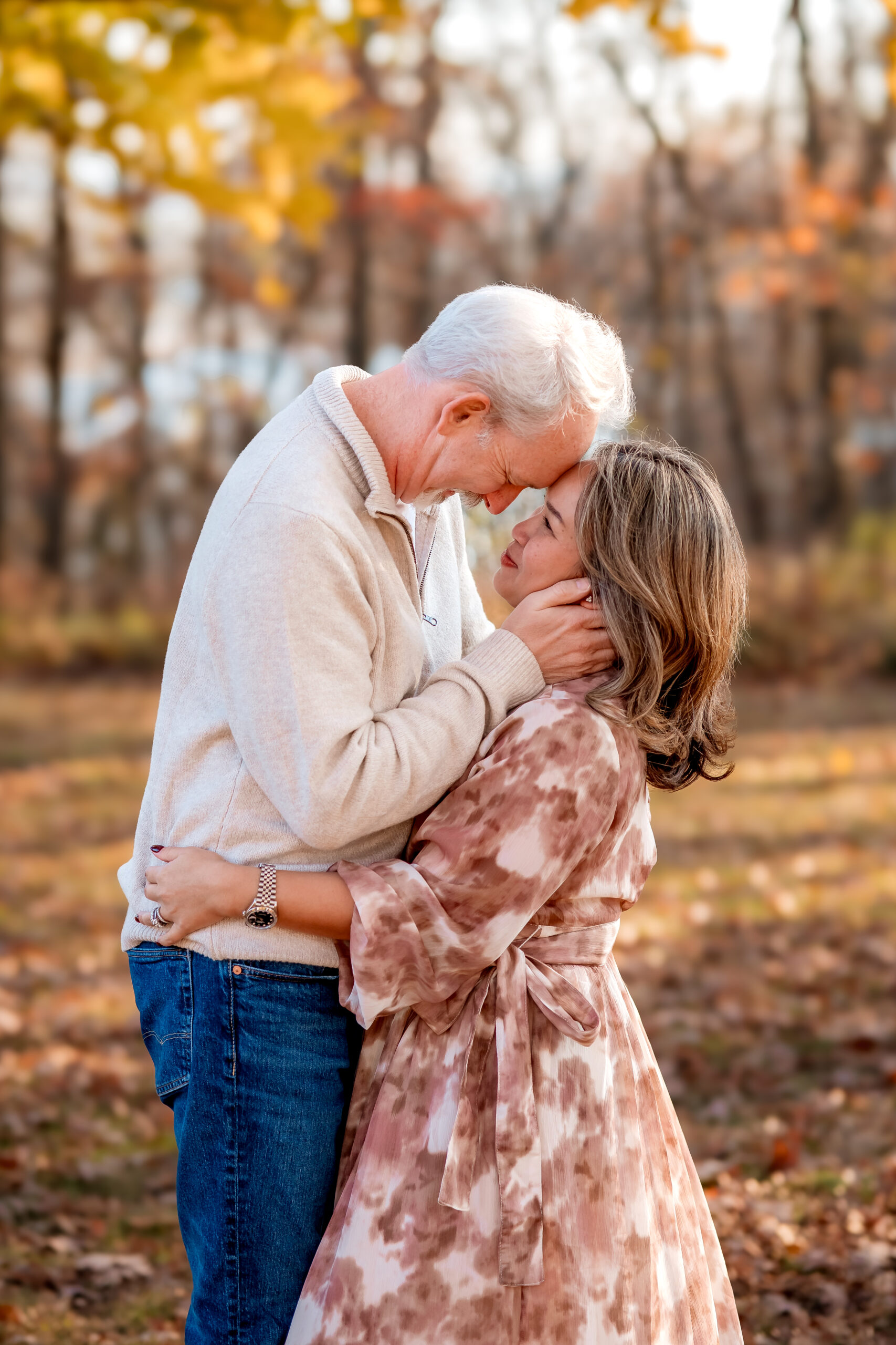 a couple is facing each other and forehead to forehead they are engaged for holiday family photography St. Louis.